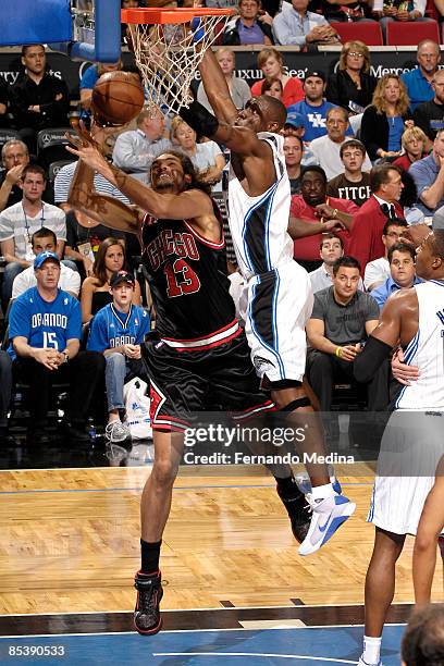 Joakim Noah of the Chicago Bulls shoots against Mickael Pietrus of the Orlando Magic during the game between the the Chicago Bulls and Orlando Magic...