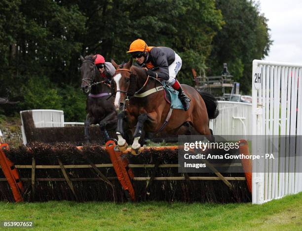 Teak ridden by Richard Johnson on their way to victory in the William Hill 80th Anniversary Handicap Hurdle at Cartmel Racecourse, Cartmel, Cumbria.