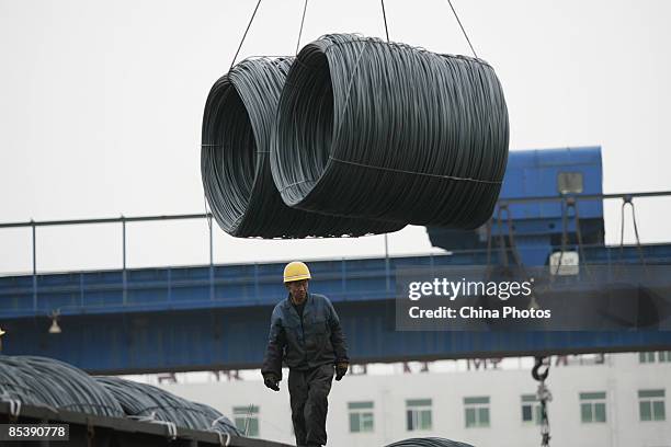 Worker works to load steel on a truck at a steel wholesale market on March 12, 2009 in Shenyang of Liaoning Province, China. According to Li Yizhong,...