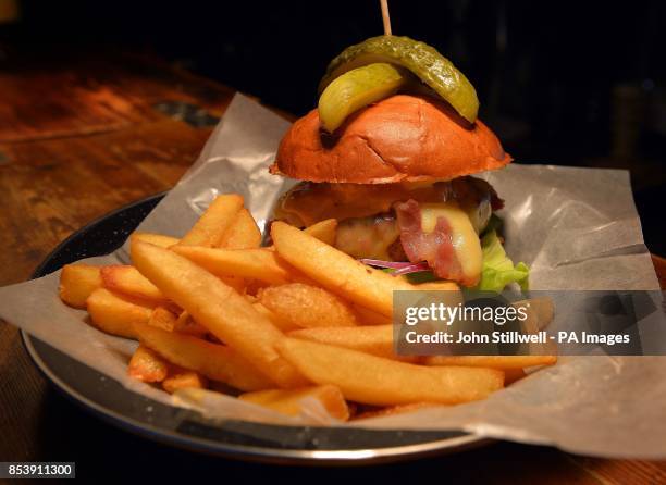 The Bukowski Burger bar in Boxpark Shoreditch east London, which serves a Fat Gringo burger , the beef patty is cooked in a chargrill oven before...