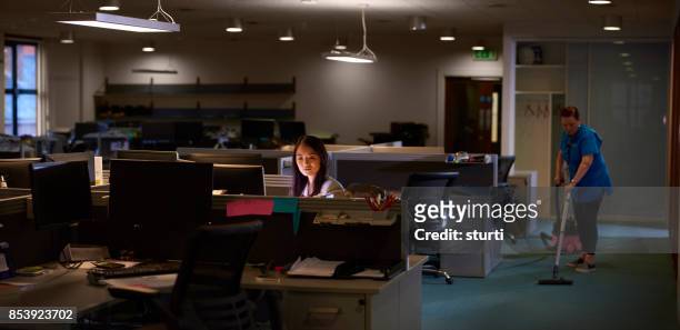 staying behind in the office - office cleaning stock pictures, royalty-free photos & images
