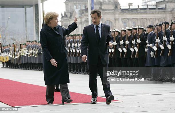 German Chancellor Angela Merkel welcomes French President Nicolas Sarkozy beside a guard of honour at the chancellery on March 12, 2009 in Berlin,...