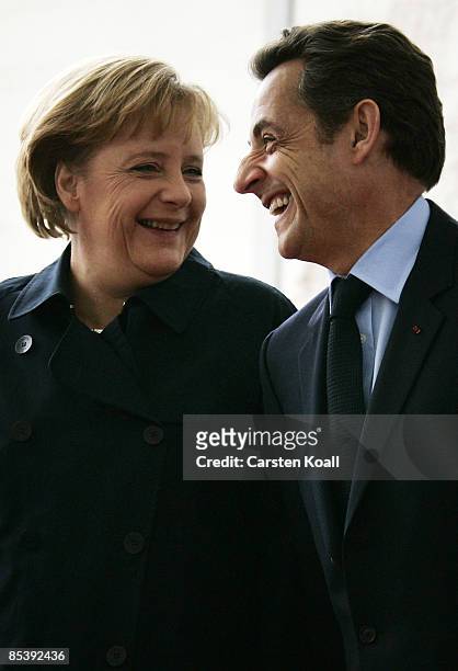 German Chancellor Angela Merkel welcomes French President Nicolas Sarkozy beside a guard of honour at the chancellery on March 12, 2009 in Berlin,...