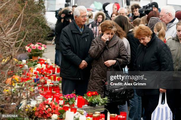 People mourn in front of the Albertville-School Centre on March 12, 2009 in Winnenden near Stuttgart, Germany. 17 - year old Tim Kretschmer, opened...