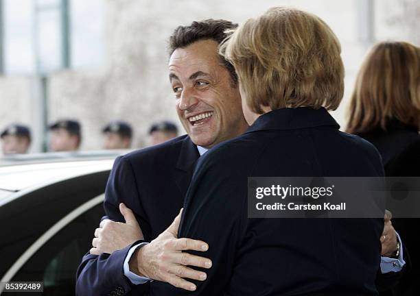 German Chancellor Angela Merkel welcomes French President Nicolas Sarkozy beside a guard of honour at the Chancellery on March 12, 2009 in Berlin,...