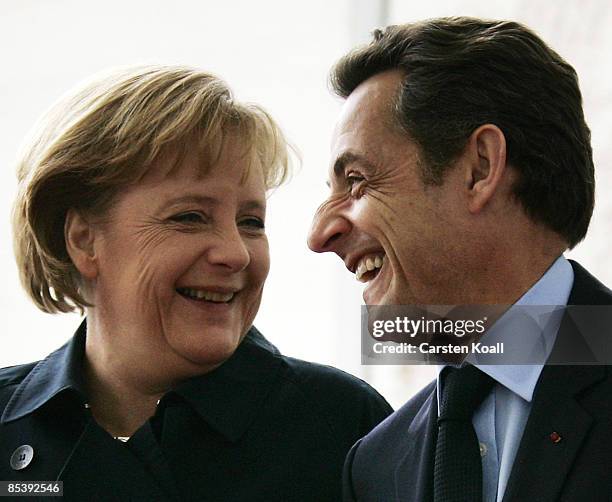 German Chancellor Angela Merkel welcomes French President Nicolas Sarkozy beside a guard of honour at the chancellery on March 12, 2009 in Berlin,...