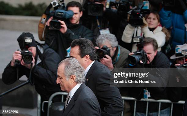 Disgraced financier Bernard Madoff passes the gathered press as he arrives at court on March 12, 2009 in New York City. Madoff was expected to plead...