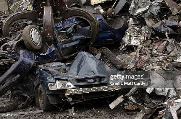 Scrap car is dragged by a mechanical dragger as it is processed in a car dismantlers and scrapyard on March 12 2009 in Radstock, England. Government...