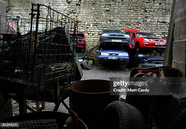 Scrap cars wait to be broken up for spares before being processed in a car dismantlers and scrapyard on March 12 2009 in Radstock, England....