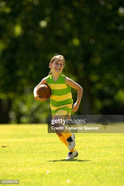 young girl with australian football - australian rules football fotografías e imágenes de stock