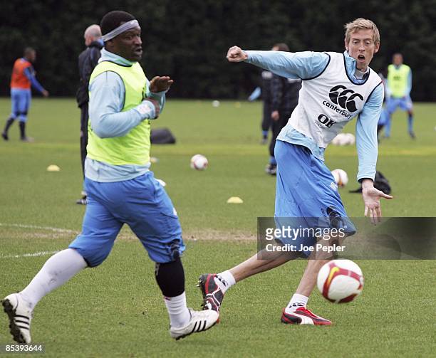 Peter Crouch and Noe Pamarot of Portsmouth FC in action during a team training session on March 12, 2009 in Eastleigh, England.