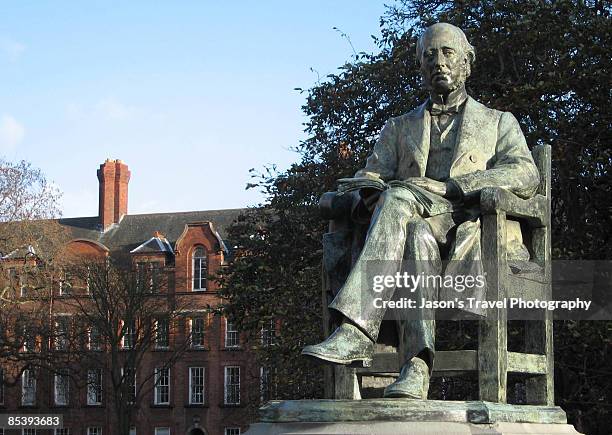 statue of a man in front of trinity college - trinity college dublin stock pictures, royalty-free photos & images