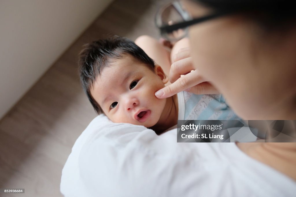 Asian mother comforting  baby