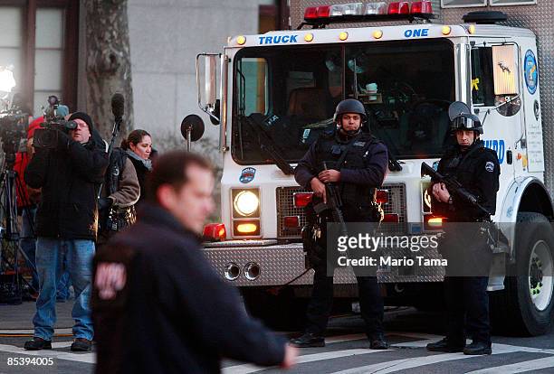 Heavily armed NYPD officers keep watch near a Manhattan Federal court where financier Bernard Madoff will appear on March 12, 2009 in New York City....