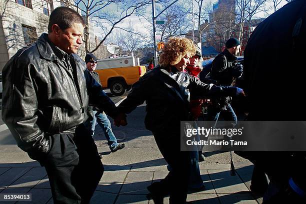 Victims Ronnie Sue Ambrosino and her husband Dominic, who had $1.6 million invested with financier Bernard Madoff, prepare to enter a Manhattan...