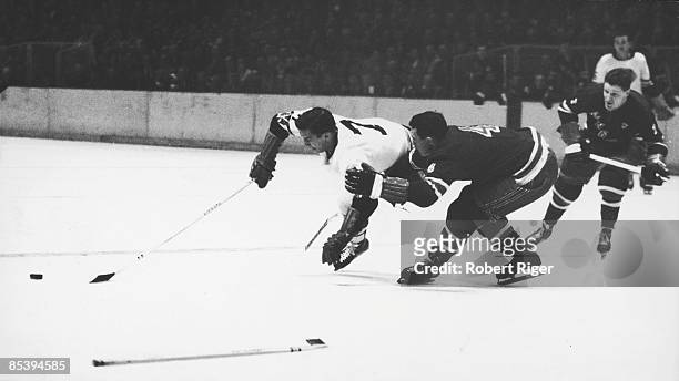 Canadian ice hockey player Bill Gadsby of the New York Rangers upends fellow Canadian Ted Lindsay of the Detroirt Red Wings, mid 1950s.