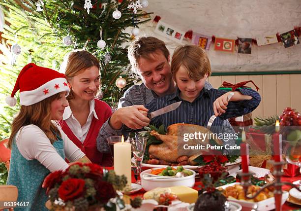 family christmas carving turkey - christmas table turkey stock pictures, royalty-free photos & images