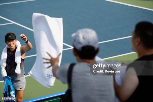 Chia-Jung Chuang of Taipei throws her tower to fans after the match between Chia-Jung Chuang of Taipei and Chen Liang of China and Andreja Klepac of...