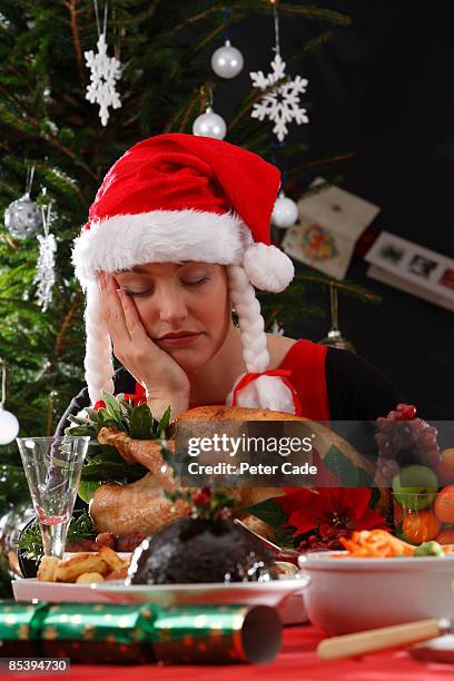 woman asleep with christmas dinner - santa hat stock pictures, royalty-free photos & images