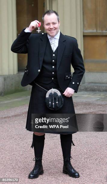 Snooker player John Higgins attends an investiture at Buckingham Palace after receiving an MBE from the Princess Royal on March 12, 2009 in London,...