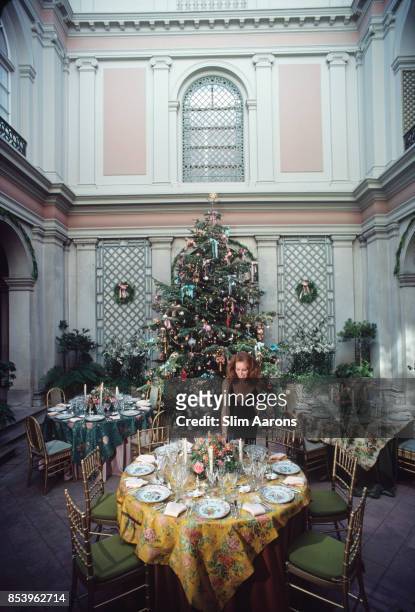 Philanthropist Ann Getty, wife of millionaire oil tycoon Gordon Getty, decorating tables for a Christmas celebration at their home in Pacific...