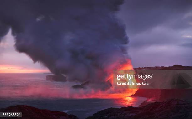 lava flow falling into the ocean in kalapana coast, hawaii - kalapana stock pictures, royalty-free photos & images