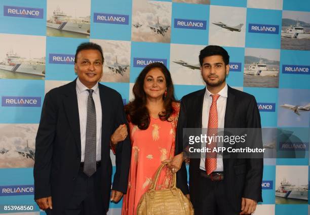 Indian industrialist and Reliance ADAG CEO Anil Ambani poses with his wife Tina and son Anmol as they arrive for the Annual General Meeting of the...