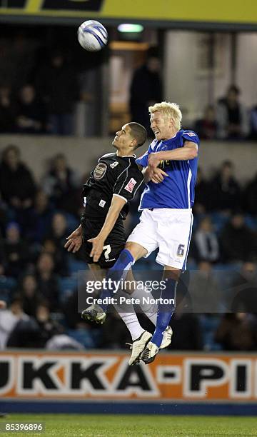 Giles Coke of Northampton Town contests the ball with Zak Whitbread of Millwall during the Coca Cola League One Match between Millwall and...