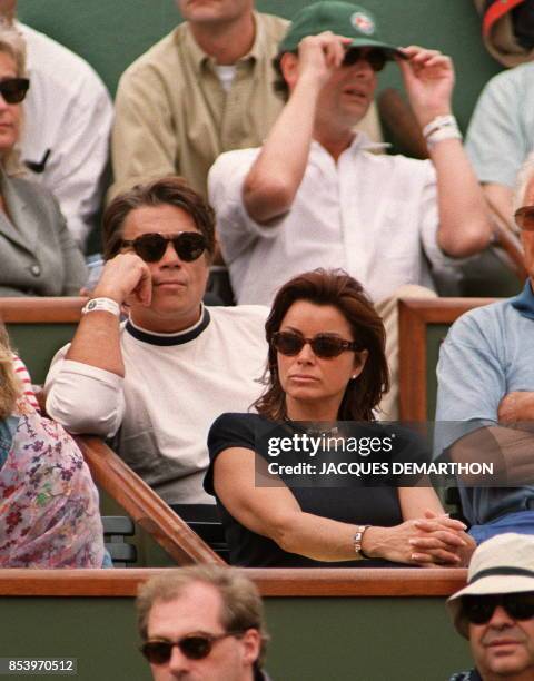 French businessman Bernard Tapie watches with his wife Dominique the men's final at the French Open in Paris 07 June. Tapie was released from jail...