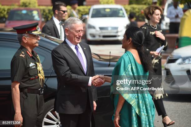 Defence Secretary Jim Mattis shakes hands with Indian Defence Minister Nirmala Sitharaman at the Indian Ministry of Defence prior to a meeting in New...