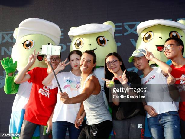 Caroline Garcia of France take a selfie with fans after a warm up exercise demonstration during Day 3 on September 26, 2017 in Wuhan, China.