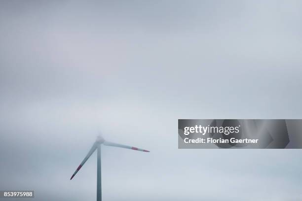 Wind turbin is pictured in the fog on September 24, 2017 in Melaune, Germany.