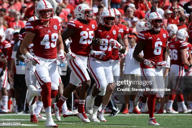 Linebacker Chris Weber of the Nebraska Cornhuskers and defensive back Antonio Reed and Freedom Akinmoladun and Eric Lee Jr. Lead the defense on the...