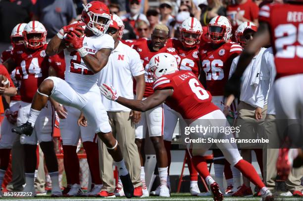 Wide receiver Dacoven Bailey of the Rutgers Scarlet Knights catches a pass in front of defensive back Eric Lee Jr. #6 of the Nebraska Cornhuskers at...