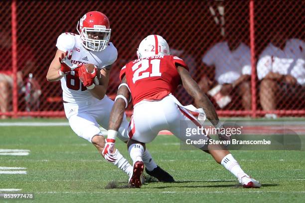 Wide receiver Hunter Hayek of the Rutgers Scarlet Knights tries to avoid the tackle from defensive back Lamar Jackson of the Nebraska Cornhuskers at...