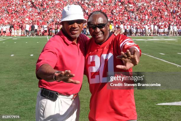 Former Heisman Trophy winners Mike Rozier and Johnny Rodgers pose during a break in the game between the Nebraska Cornhuskers and the Rutgers Scarlet...