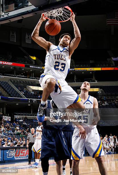 Jerome Jordan of the Tulsa Golden Hurricane dunks the ball past Lawrence Ghoram of the Rice Owls during the Quarterfinals of the Conference USA...