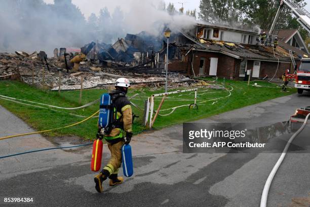 Firemen work at the mosque in the Vivalla area of Örebro in Sweden, that was seriously damaged in a fire Monday night, September 26, 2017. Police are...