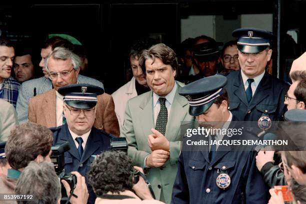 Bankrupt French politician Bernard Tapie, flanked by policemen, leaves the Valenciennes court, northern France, on May 15, 1995. - Tapie, a...