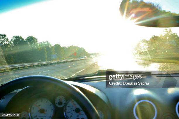 dashboard view of a moving car viewing the bright sunlight - car dashboard windscreen stock pictures, royalty-free photos & images