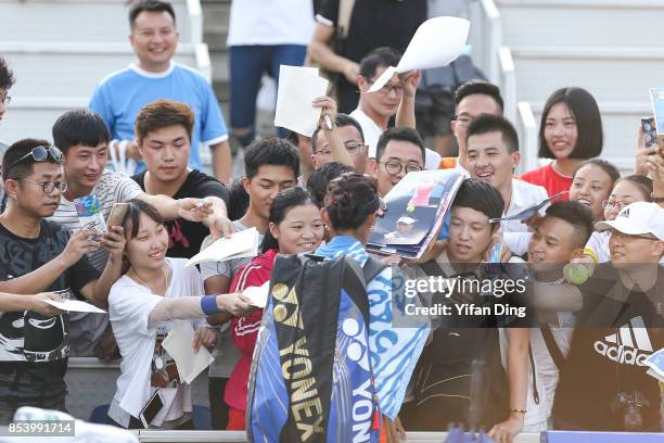 Wang Qiang of China signs autographs for the audience after winning the second round Ladies Singles match against Sorana Cirstea of Romania on Day 3...