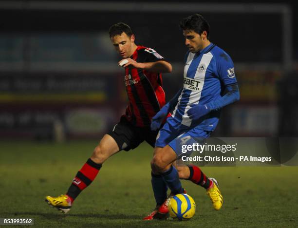 Bournemouth's Marc Pugh in action against Wigan Athletic's Jordi Gomez during the FA Cup Third Round Replay at Goldsands Stadium, Bournemouth.