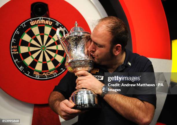 England's Scott Waites celebrates with the trophy after winning the BDO World Professional Darts Championships at the Lakeside Complex, Surrey.