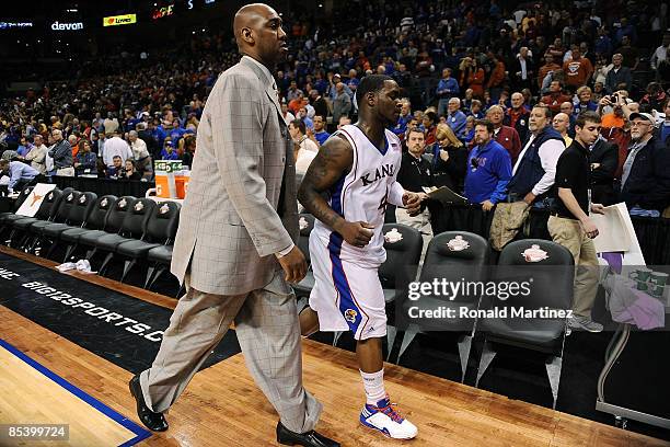 Assistant coach, Danny Manning and Sherron Collins of the Kansas Jayhawks walk off the court after a loss to the Baylor Bears during the Phillips 66...