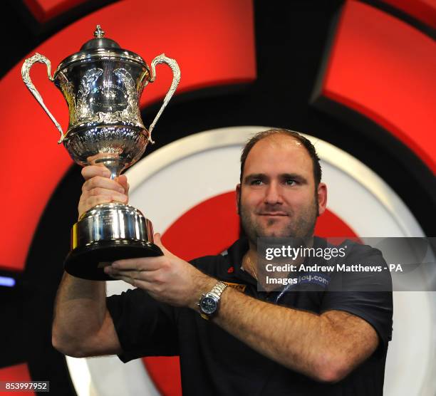 England's Scott Waites celebrates with the trophy after winning the BDO World Professional Darts Championships at the Lakeside Complex, Surrey.