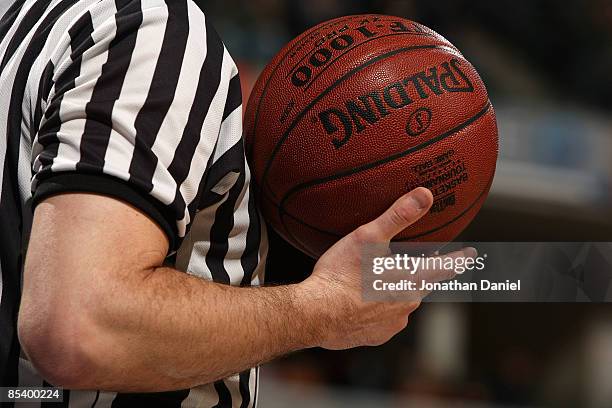 Detail of a referee holding a Spalding basketball as the Minnesota Golden Gophers play against the Northwestern Wildcats during the first round of...