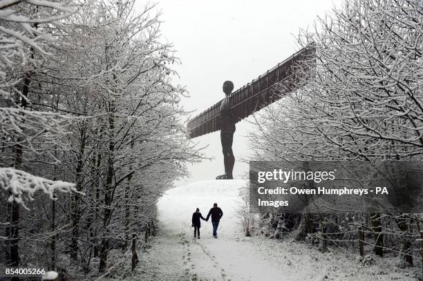 Richard and Samantha Stretton from Newcastle enjoy a walk at the Angel of the North in Gateshead, after heavy snowfall, as the first wave of snow...