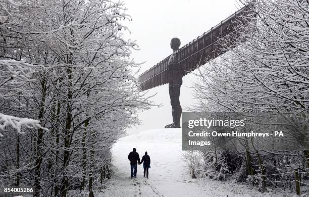 After heavy snowfall Richard and Samantha Stretton, of Newcastle, enjoy a walk at the Angel of the North in Gateshead.
