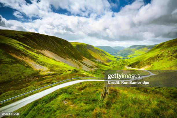 landscape of dramatic mountain road off into distant landscape - montes cambrianos fotografías e imágenes de stock