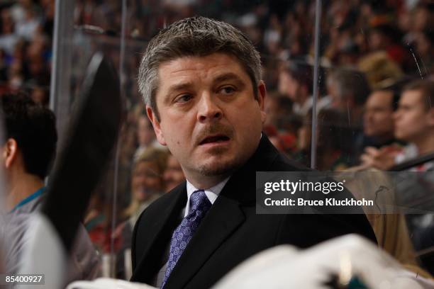 Head Coach Todd McLellan of the San Jose Sharks stands behind the bench against the Minnesota Wild during the game at the Xcel Energy Center on March...